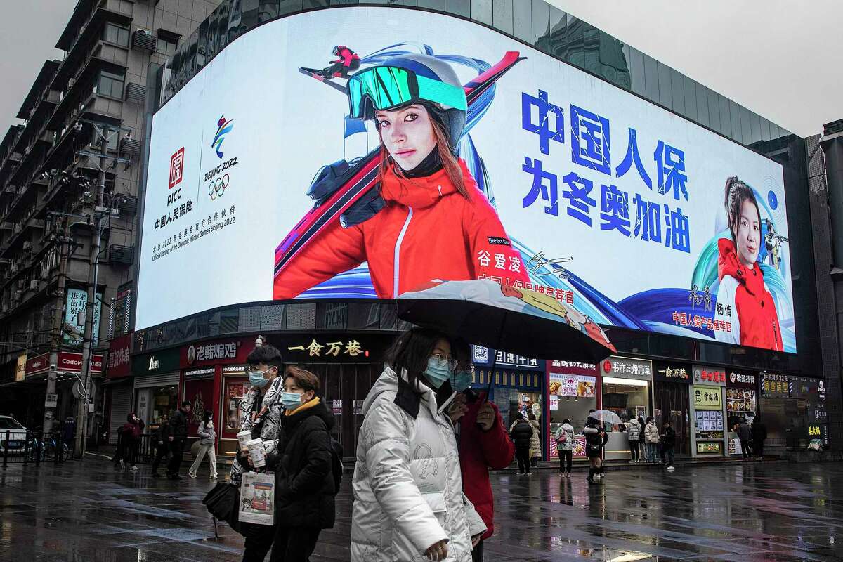 Advertising featuring Olympic skier Eileen Gu plays on a video screen in Wuhan, China, on Friday. Gu, a San Francisco native, has competed for China since 2019. Her endorsements deals include Victoria’s Secret, Cadillac, Mengniu, Anta sports, Luckin Coffee, Louis Vuitton and more than 20 other brands.