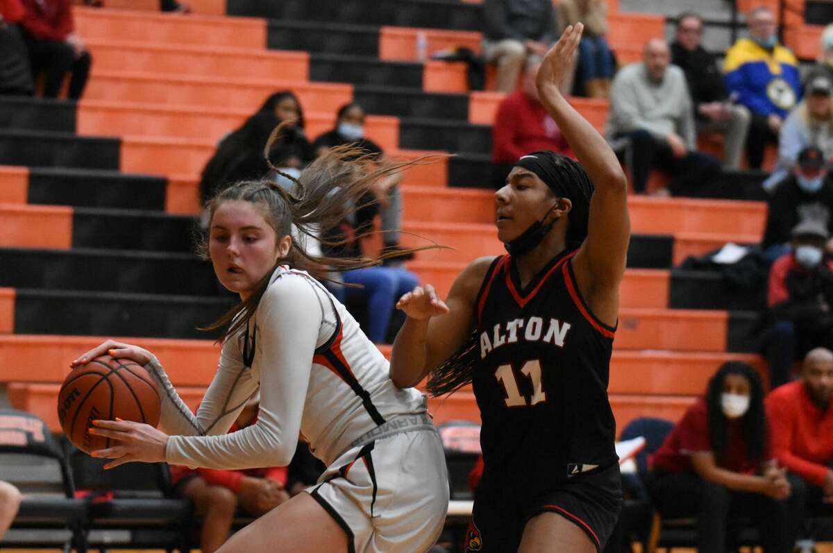 Edwardsville's Elle Evans makes space for herself in the post during the first half against the Alton Redbirds in the Class 4A Edwardsville Regional championship game on Friday in Edwardsville.