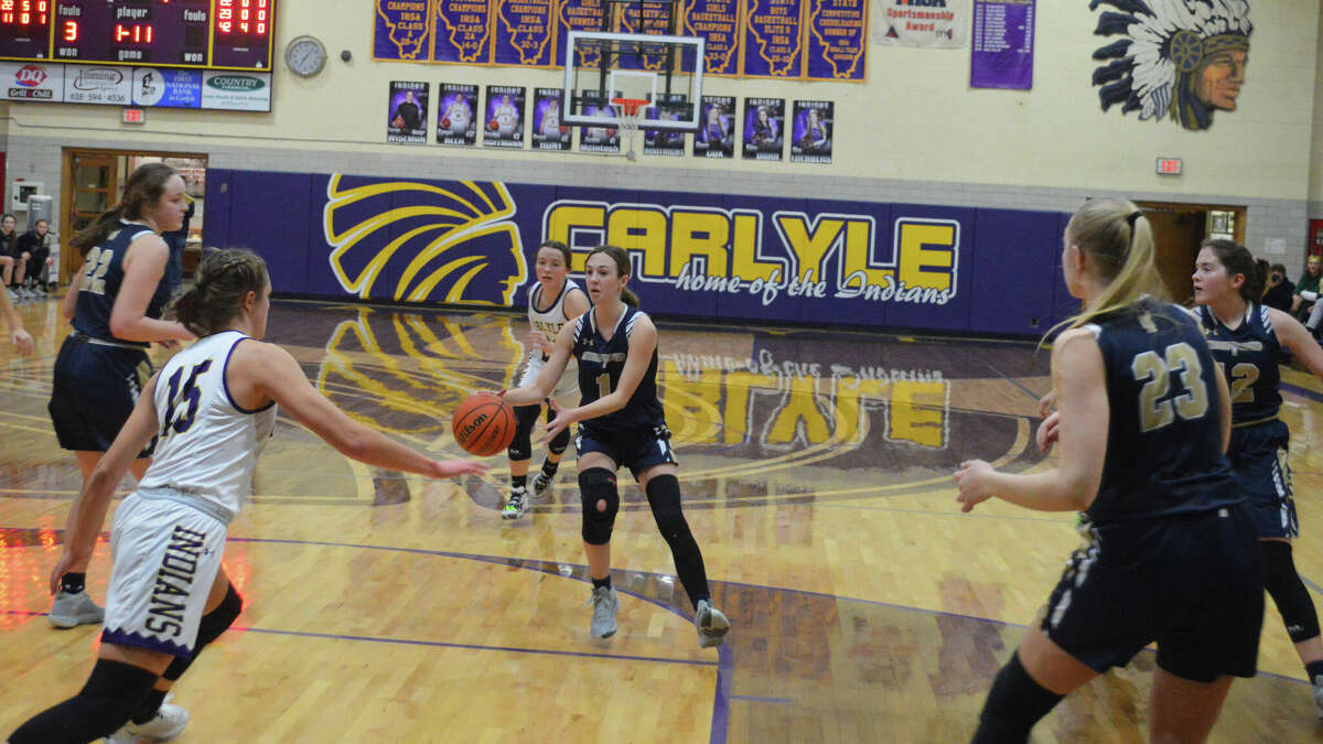 Mary Harkins looks for an open teammates against Carlyle in the Class 1A Carlyle Regional Championship game. Carlyle beat FMCHS 51-39. 