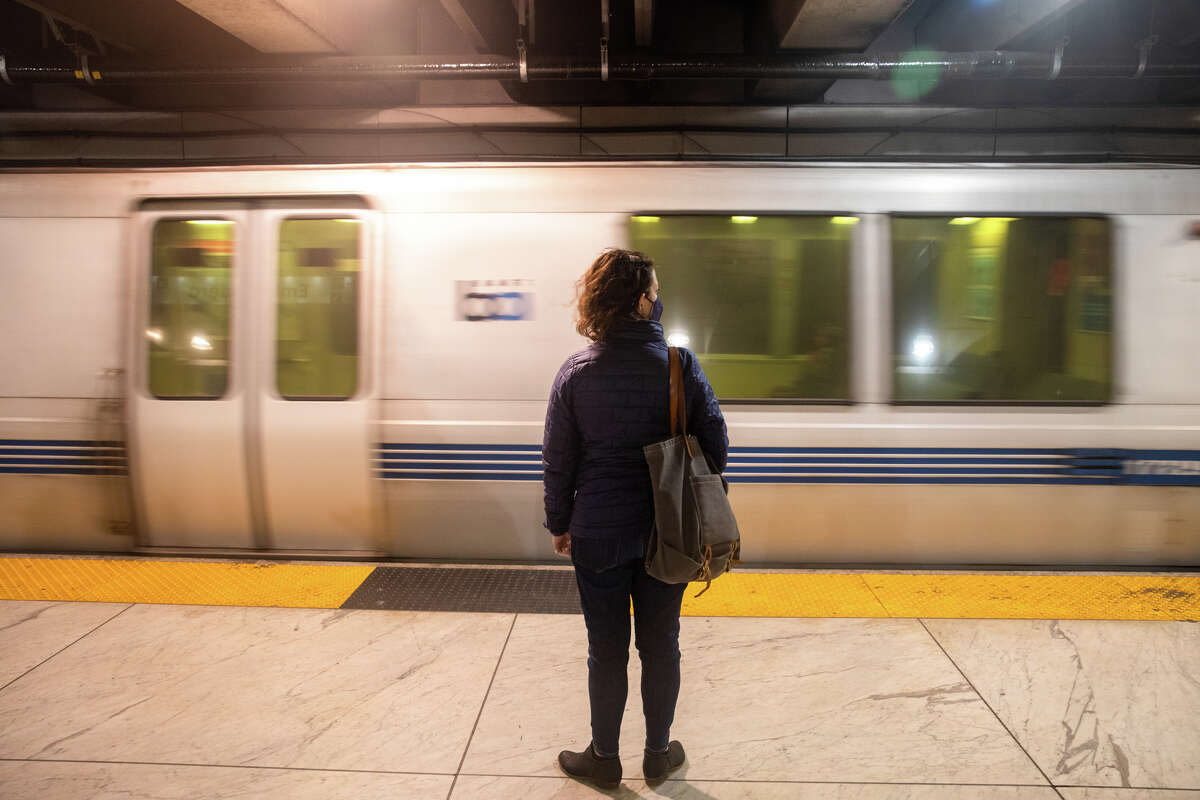 A passenger waits to board a BART train in San Francisco on Feb. 15.