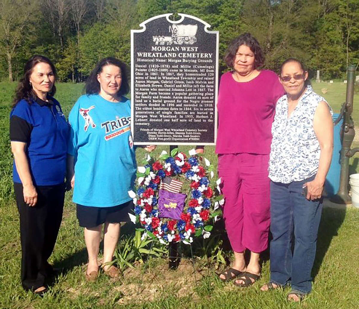 From left, Diana Green, Marsha Sanders, Dorothy Allen and Deonna Green, Friends of Morgan Wheatland and Norman/Cummings Cemetery Society, stands with the newly erected historical marker at Morgan West Wheatland Cemetery in 2014.