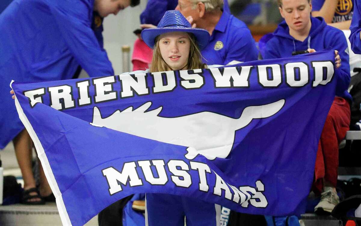 A Friendswood High School swimmer holds a flag before the UIL State Swimming and Diving Championships Saturday in Austin.