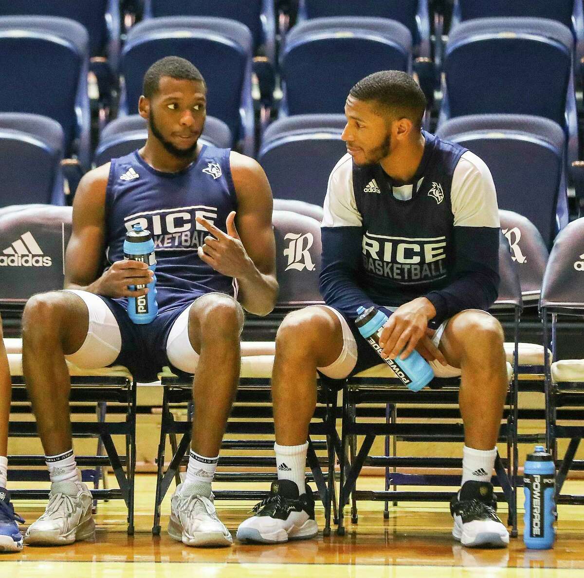 Rice basketball players Carl Pierre, left, and Travis Evee take a water break during practice at Tudor Field House on the campus of Rice University on Thursday, Feb. 10, 2022 in Houston.