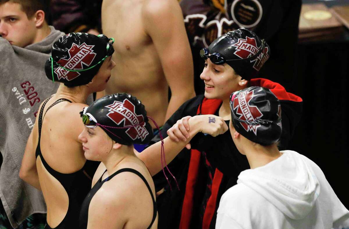 Magnolia swimmers dance before competing in the Class 5A girls 200-yard medley relay during the UIL State Swimming and Diving Championships at Lee & Joe Jamail Texas Swimming Center, Saturday, Feb. 19, 2022, in Austin.