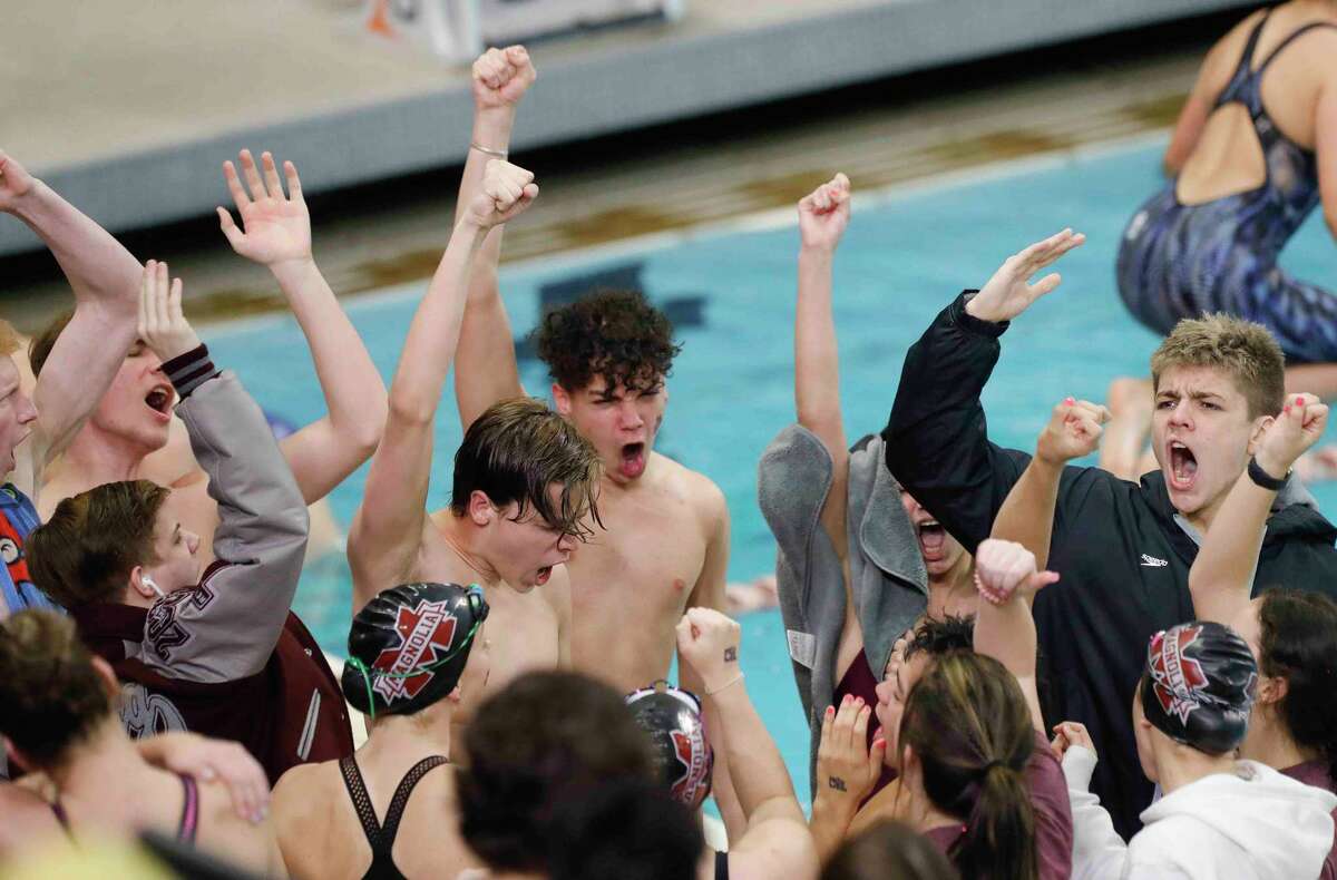 Magnolia swimmers cheer before the UIL State Swimming and Diving Championships at Lee & Joe Jamail Texas Swimming Center, Saturday, Feb. 19, 2022, in Austin.