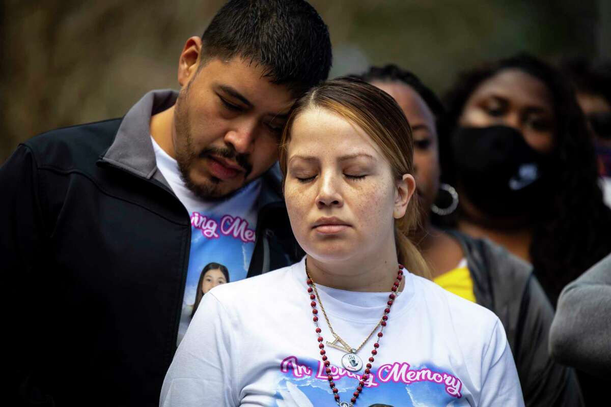 Armando and Gwen Álvarez prepare to march for their 9-year-old daughter, Arlene Álvarez, who was mistakenly shot and killed by a robbery victim on Valentine's night, near the intersection where the shooting happened next to a Chase Bank location in southeast Houston, Saturday, Feb. 19, 2022.