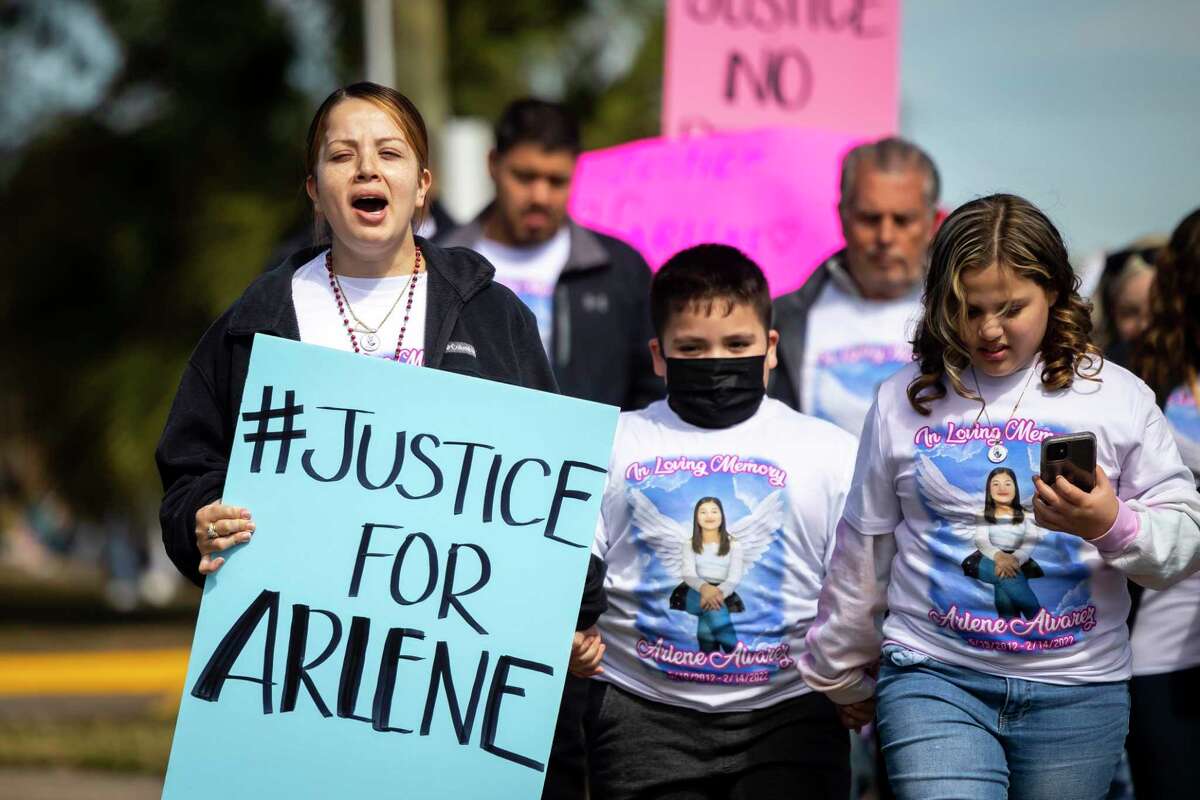 Gwen Álvarez is accompanied by her extended family as she leads a march for her 9-year-old daughter, Arlene Álvarez, who was mistakenly shot and killed by a robbery victim on Valentine's night, near the intersection where the shooting happened in southeast Houston, Saturday, Feb. 19, 2022.
