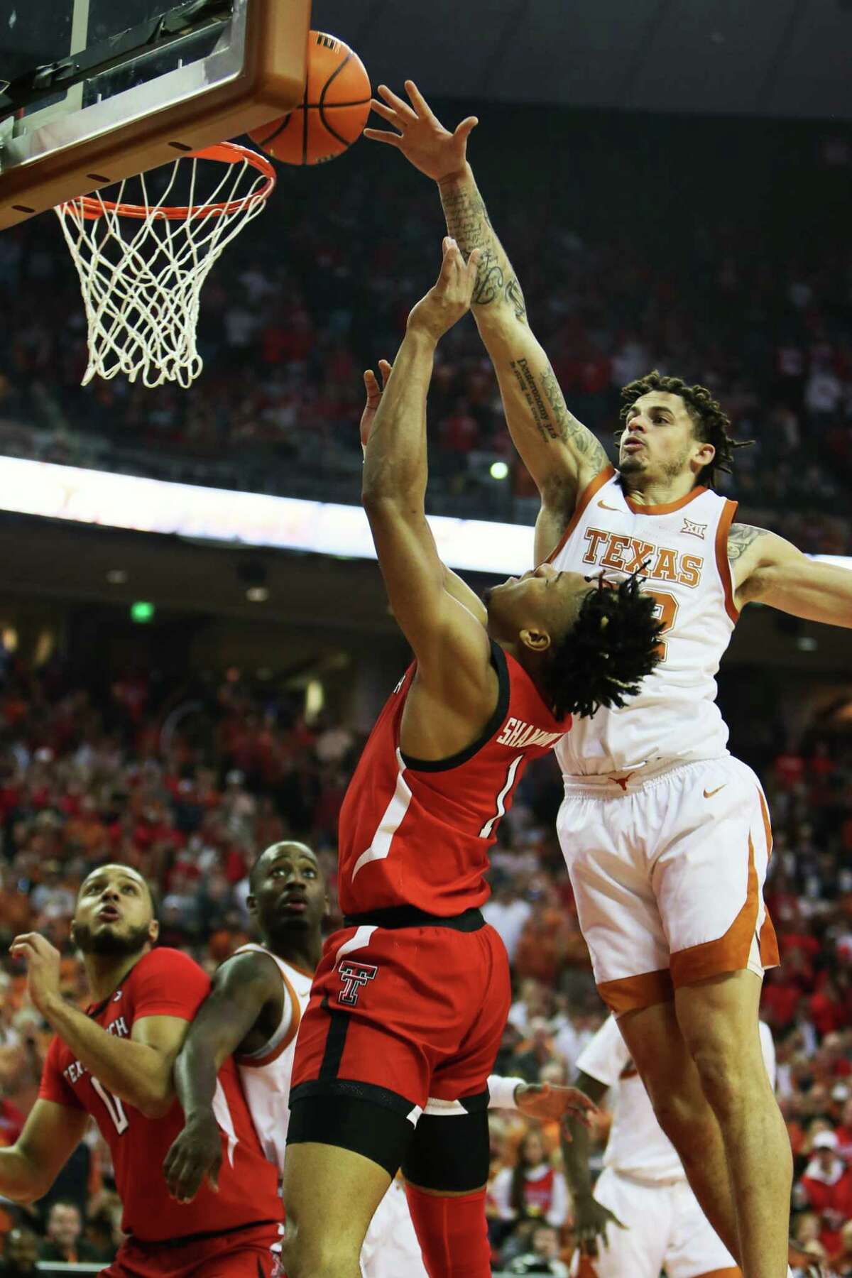 Texas Longhorns forward Christian Bishop (32) defends the shot of Texas Tech Red Raiders guard Terrence Shannon Jr. (1) during the Big 12 basketball game against the Texas Tech Red Raiders Saturday, Feb. 19, 2022, at The Frank Erwin Center in Austin, Texas. [Sam Grenadier/San Antonio Express-News]