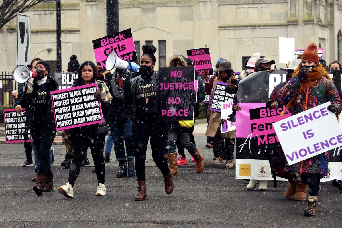 Participants in the Black Women Speak march make their way through downtown on as they walk to a rally in front of the Morton Government Center, in Bridgeport, Conn. Feb. 19, 2022.