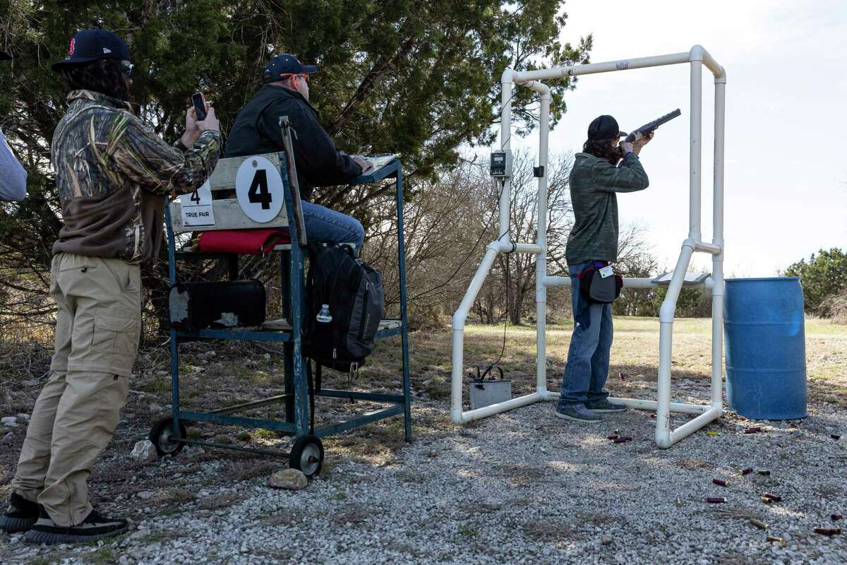Aidan Symens, right, competes in the sporting clays event during the San Antonio Stock Show & Rodeo Junior Shoot-Out at the National Shooting Complex on the city’s West Side.
