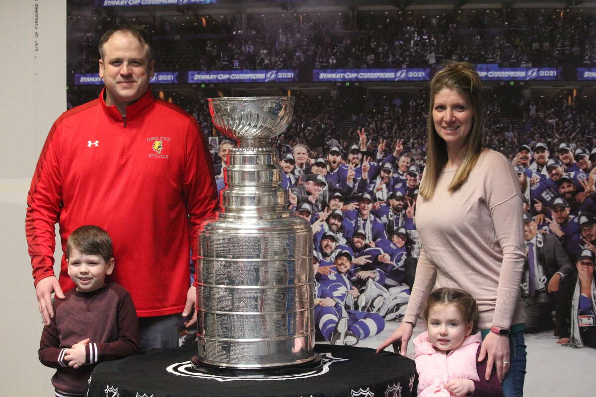 Big Rapids hockey coach Tim Blashill and his family pose with the Stanley Cup on Saturday at the Ewigleben Ice Arena.