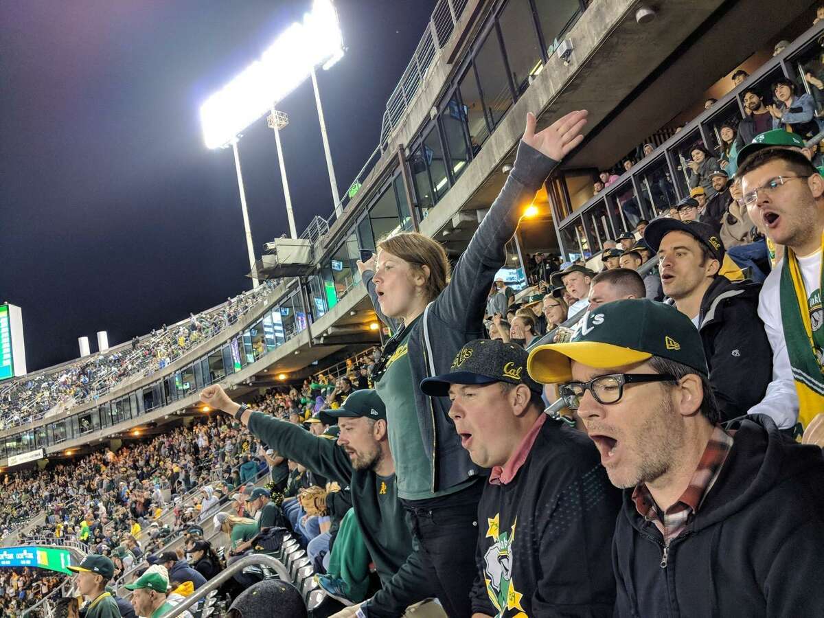 Hannah Tomlinson, an A's fan from London, led a UK group at the Coliseum in cheers on a fireworks night in 2018.