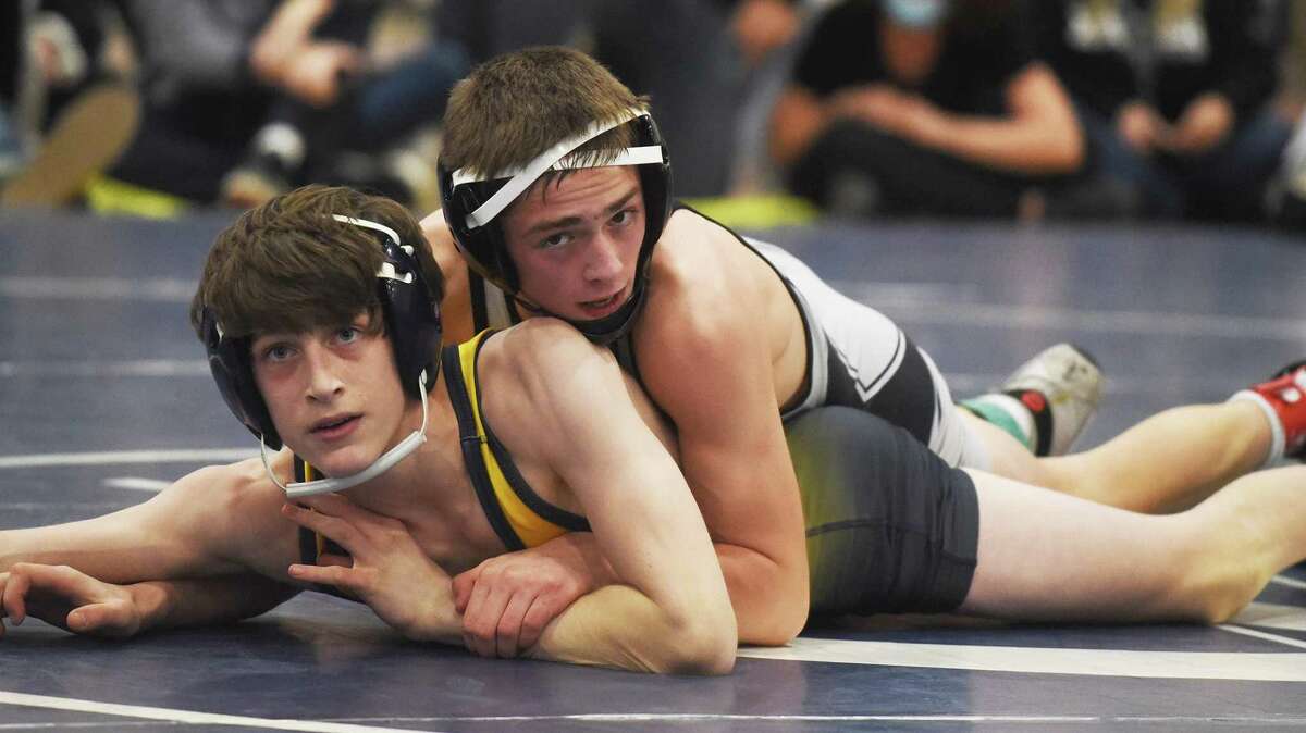 Xavier’s Max Morse, top, wrestles Simsbury’s Griffin DeVivo in the 113-pound final at the Class L championship in Wilton on Saturday.
