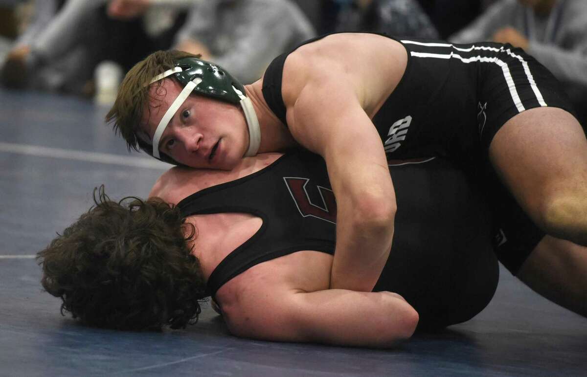 Guilford’s Brent Strand, top, wrestles Farmington’s Shane Hurley in the 182-pound final at the Class L championship on Saturday in Wilton.