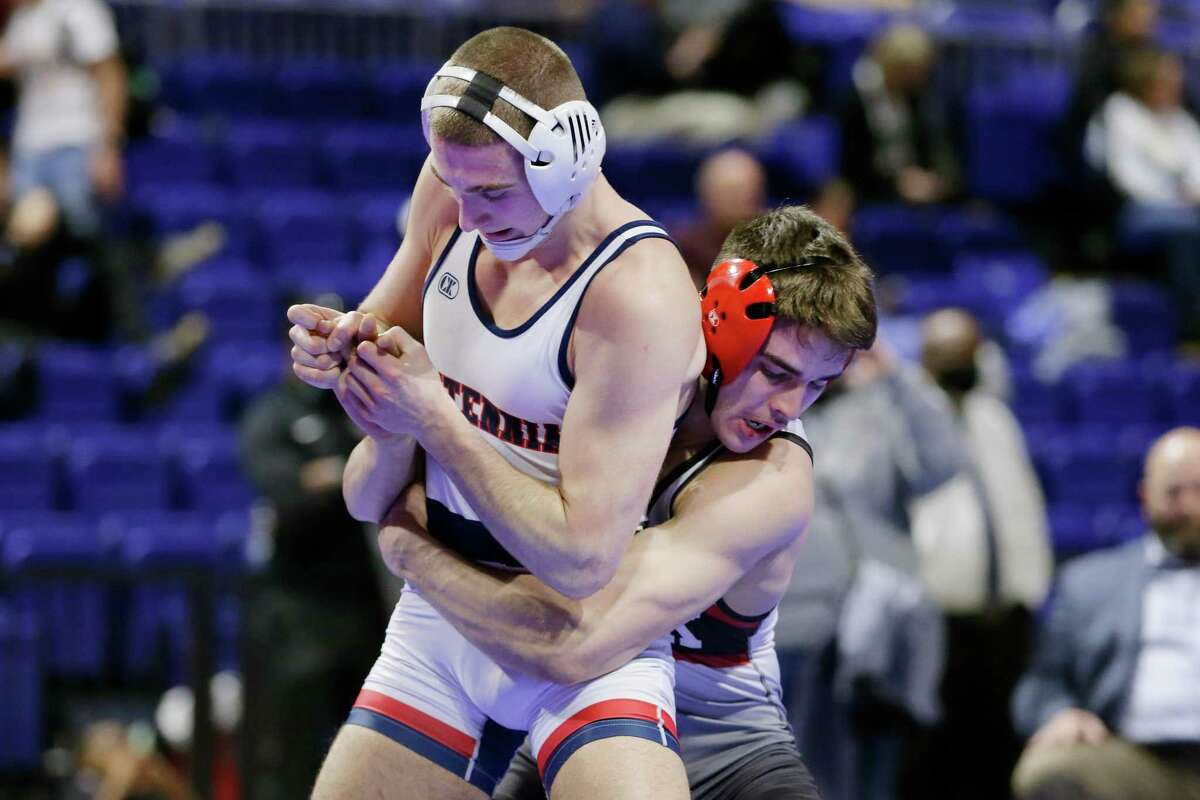 Jasin Sejdini of Frisco Centennial, left, and Joshua Thomas of Caney Creek, right, trade grapples for advantage during their Boys 5A 160 weight class match in the UIL state wrestling championship tournament Saturday, Feb. 19, 2022 in Cypress, TX.