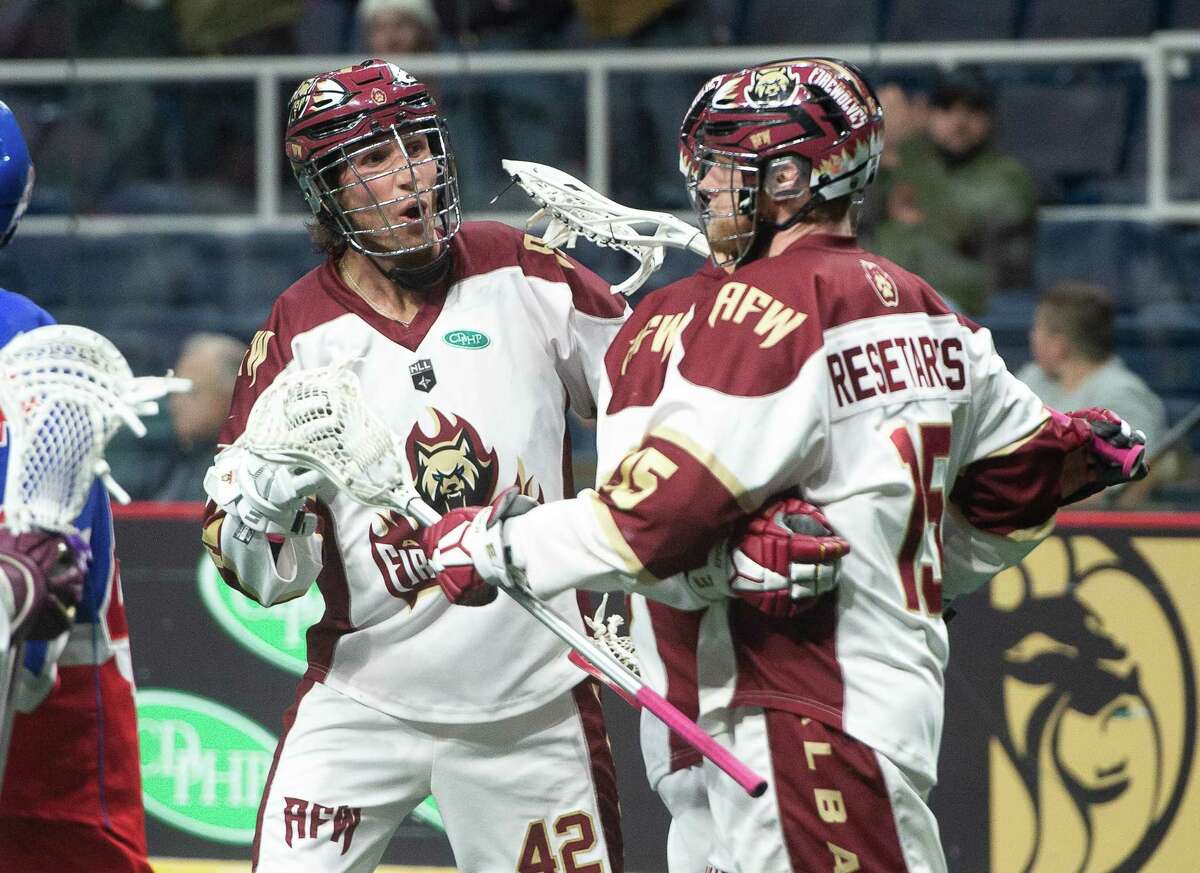 Albany forward Andrew Kew (42) and Joe Resetarits, shown celebrating a goal against Toronto on Feb. 19, helped the FireWolves win 11-7 at Vancouver on Saturday night. (Jenn March/Special to the Times Union)