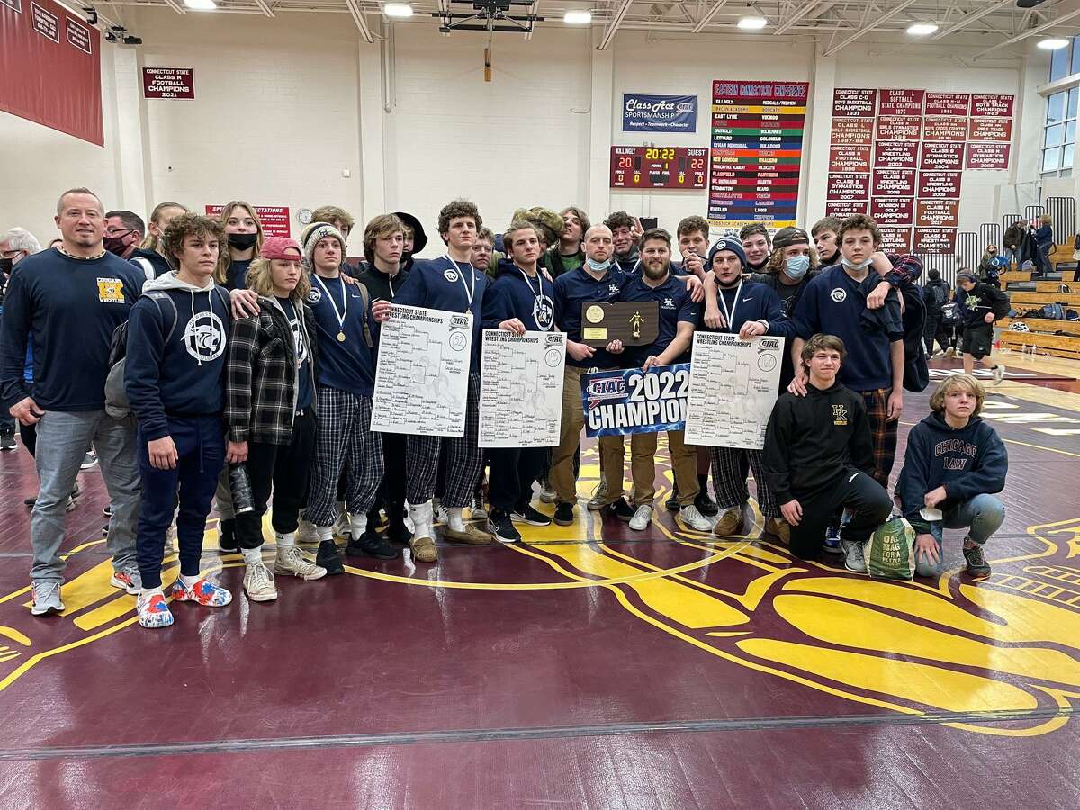 Members of the Haddam-Killingworth wrestling team celebrate after the Cougars won their first state title in the sport with the Class S championship Saturday at Killingly High School.