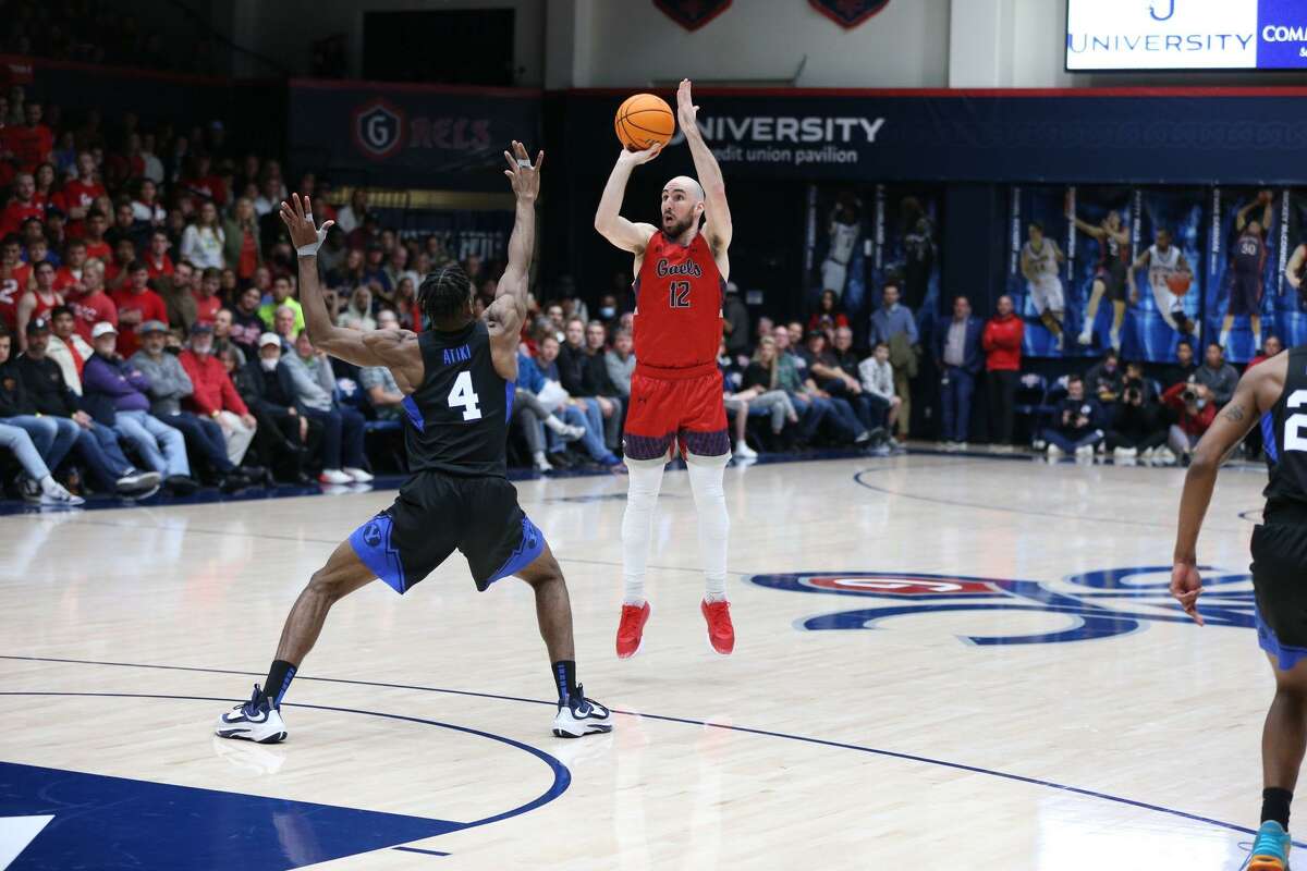 St. Mary's Tommy Kuhse attempts a 3-pointer over BYU's Atiki Ally Atiki.
