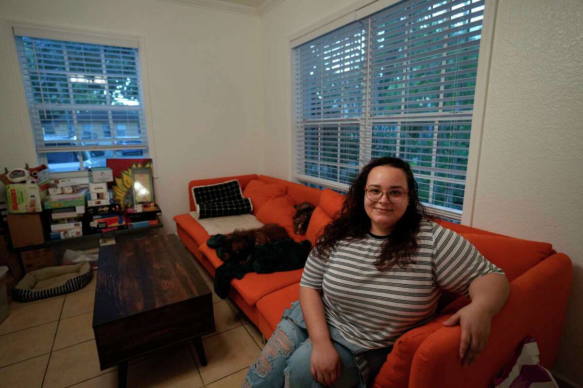 Krystal Guerra, 32, poses for a picture inside her apartment, which she is in the process of packing up to leave after her new landlord gave her less than a month's notice that her rent would go up by 26%, Saturday, Feb. 12, 2022, in the Coral Way neighborhood of Miami. Guerra, who works in marketing while also pursuing a degree part-time, had already been spending nearly 50% of her monthly income on rent prior to the increase. Unable to afford a comparable apartment in the area as rents throughout the city have risen dramatically, Guerra is putting many of her belongings into storage and moving in with her boyfriend and his daughter for the time being.