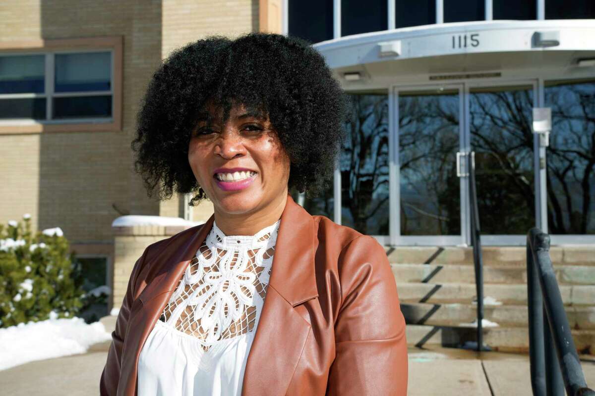 Alexis Knox-Miller, equity director for the Colorado Springs, Colo., school system, poses Friday, Feb. 4, 2022, outside the district's main office in Colorado Springs, Colo. Educators say they are feeling the impacts of deep ideological divides around issues of diversity and equity in schools. After George Floyd’s killing at the hands of police in 2020, many school districts stepped up efforts to make schools more comfortable, inclusive places for students and staff of all backgrounds. But intense debate over how schools deal with race is leading some districts to rethink and in some cases reverse plans.