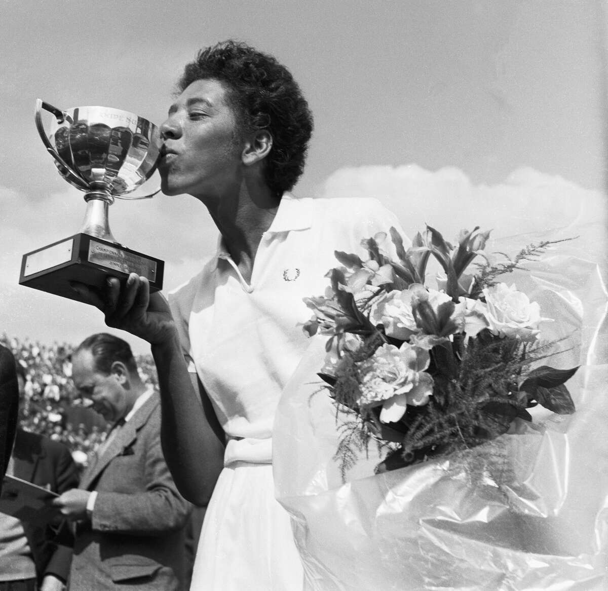 Althea Gibson kisses the cup she was rewarded with after having won the French International Tennis Championships in Paris.