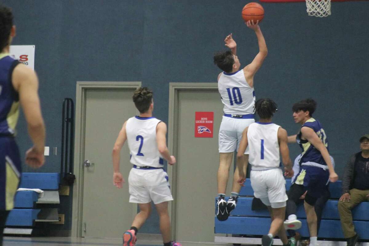 FBCA's Matthew Ybarra (10) goes looking for two of his game-high 21 points as Donald Guillory (1) and Nick Gay look on, hoping there won't be a need for a putback.
