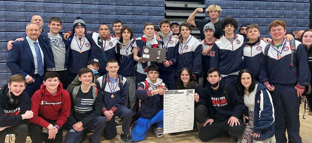 Foran's wrestling team celebrate Antonio Madero's title and team placing second at Class M championship.