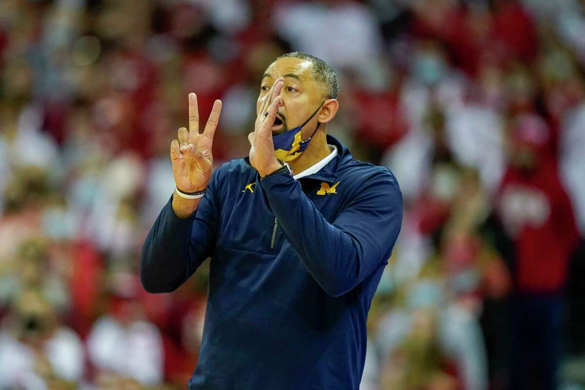 Michigan head coach Juwan Howard directs his team during the first half of an NCAA college basketball game against Wisconsin Sunday, Feb. 20, 2022, in Madison, Wis. Wisconsin won 77-63. (AP Photo/Andy Manis)