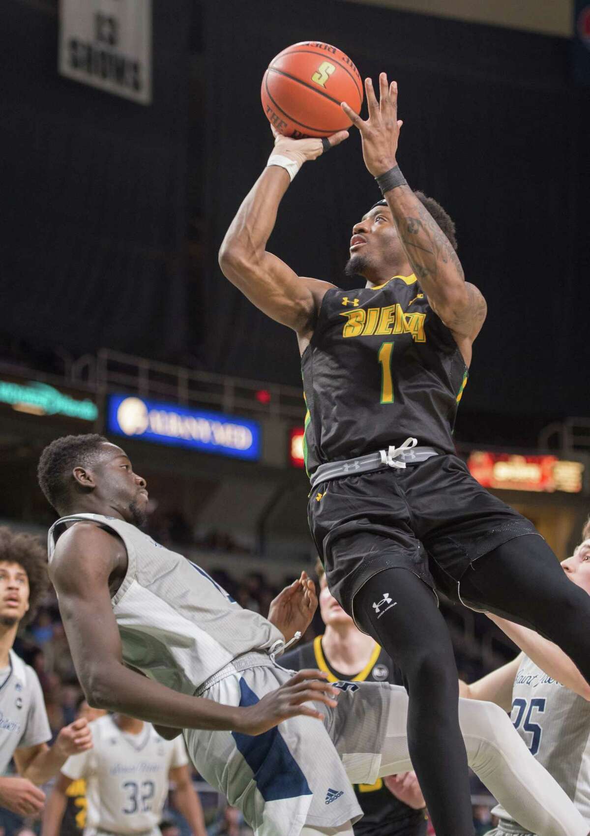 Siena guard Jared Billups shoots the ball as he bumps St. Peter’s forward Hasan Drame during a game on Sunday, Feb. 20, 2022 at MVP Arena in Albany, N.Y. (Jenn March, Special to the Times Union)