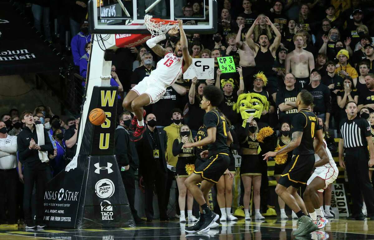 Houston's J'wan Roberts dunks the ball with one second left in double overtime against Wichita State to give Houston a win in an NCAA college basketball game on Sunday, Feb. 20, 2022, in Wichita, Kan. (Travis Heying/The Wichita Eagle via AP)