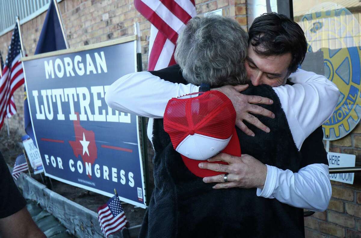 Morgan Luttrell, a congressional candidate, greets Vicki Fullerton before the Texas First Rally on Saturday, Feb. 19, 2022, at Honor Cafe in Conroe. He removed his hat each time he greeted a woman in the line.