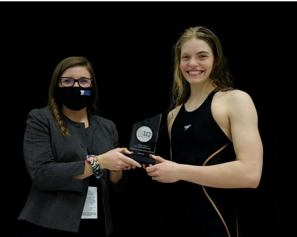 Michigan's Claire Newman (left) receives an award during the Big Ten Championship held in Madison, Wis., Feb. 16-19, 2022.