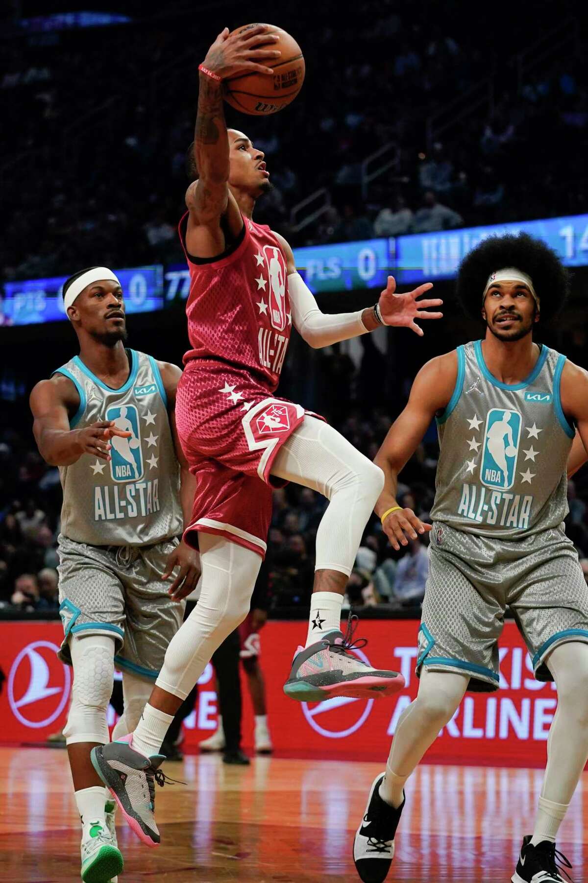 San Antonio Spurs' Dejounte Murray, center, drives to the hoop during the first half of the NBA All-Star basketball game, Sunday, Feb. 20, 2022, in Cleveland.