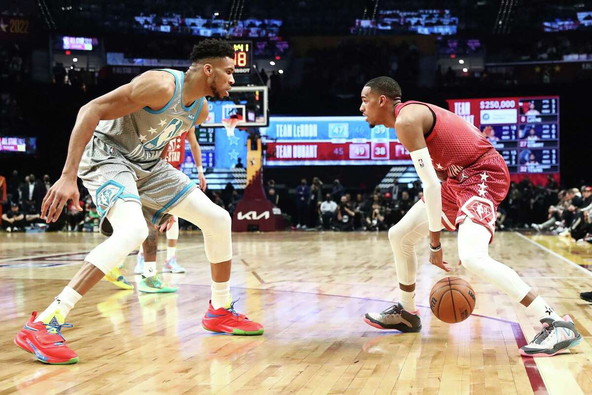 The Spurs’ Dejounte Murray, right, of Team Durant dibbles against the Bucks’ Giannis Antetokounmpo of Team LeBron in the third quarter of the NBA All-Star Game at Rocket Mortgage FieldHouse on Feb. 20, 2022 in Cleveland.