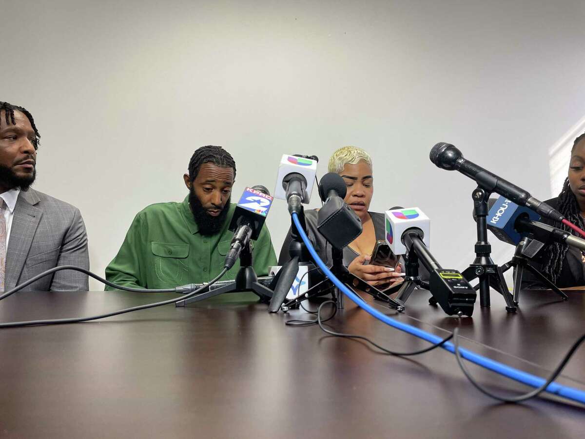 Tony Earls, second from left, who is charged with aggravated assault with bodily injury in the shooting death of the 9-year-old, sits at a press conference on which his lawyer spoke on his behalf, Monday, Feb. 21, 2022, in Houston.