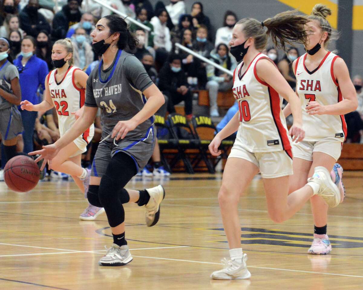 Amani Abuhatab of West Haven beats Meghan Kirck and Carina Ciampi of Savred Heart Academy to the basket during an SCC semifinal on Monday.