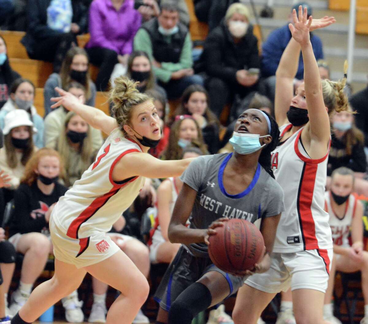 Dea Howard of West Haven goes past Carina Ciampi (3) of Sacred Heart Academy during an SCC semifinal on Monday.