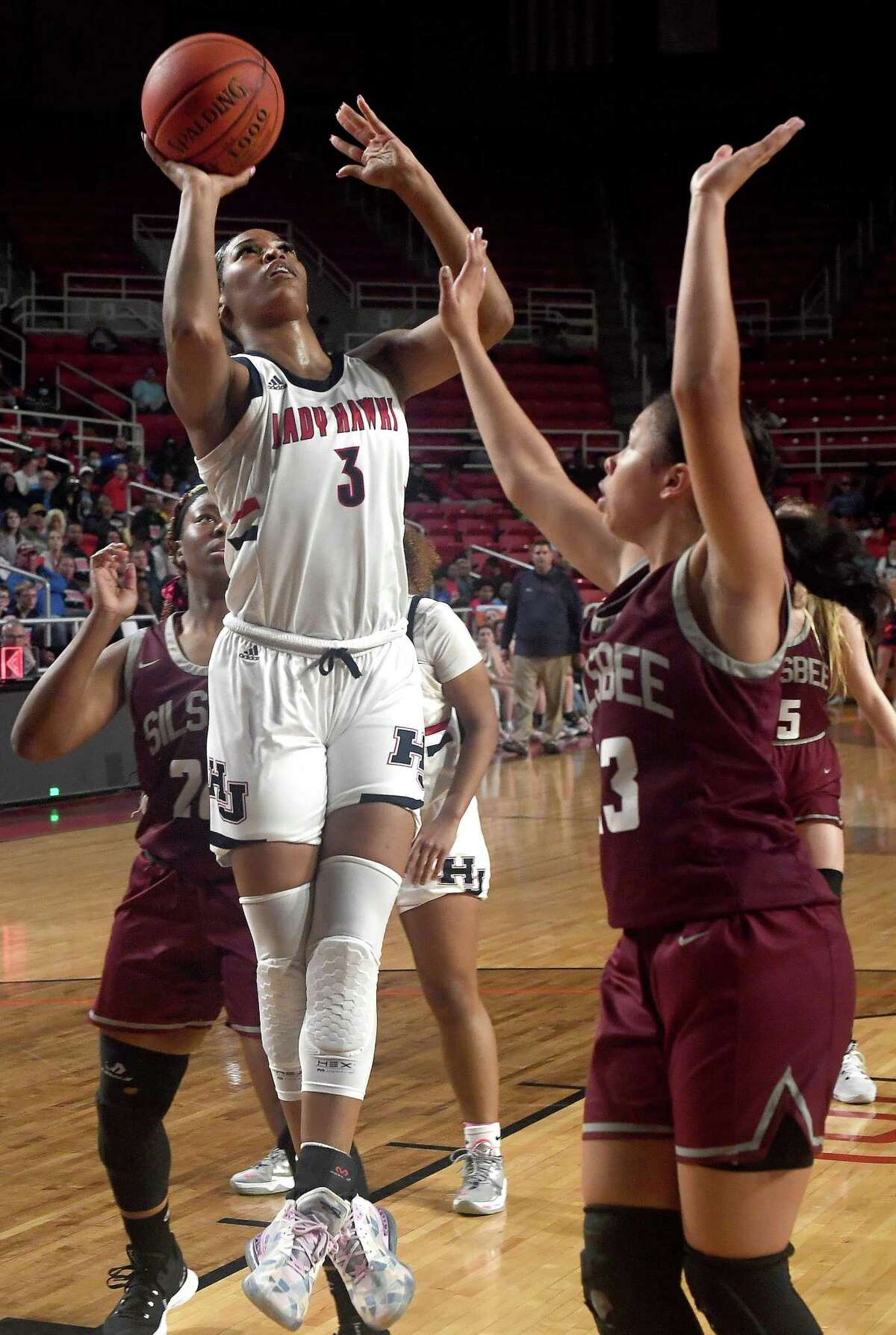 Hardin-Jefferson's Ashlon Jackson gets up a shot over Silsbee's Monica Bottley during their playoff match-up at the Montagne Center. Photo made Monday, February 21, 2022 Kim Brent/The Enterprise