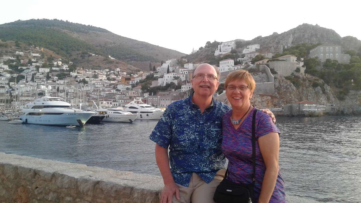Midland travelers Art and Crystal Prunier pose for a photo in the harbor on the Greek island of Hydra in 2019.  