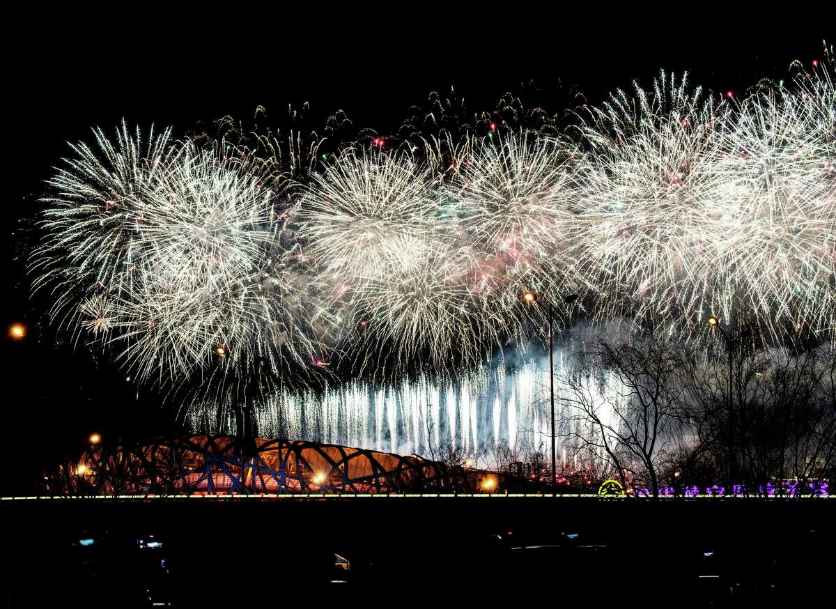 Fireworks explode over the Beijing National Stadium, also known as the Birds Nest, and the city skyline during the closing ceremony of the Beijing 2022 Winter Olympics on Sunday, Feb. 20, 2022 in Beijing, China. (Andrea Verdelli/Getty Images/TNS)