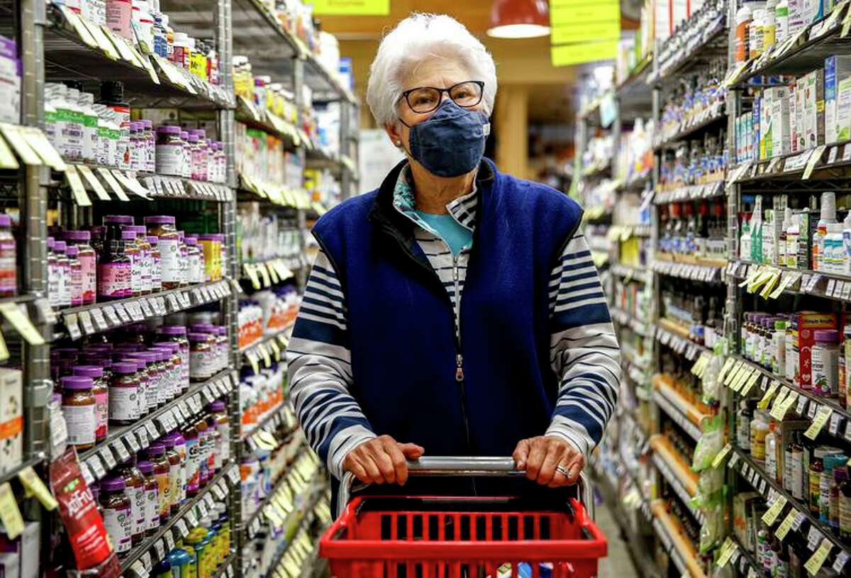 Linda Kamby shops at Alameda Natural Grocery in Alameda. Indoor masks are no longer required by California, and Bay Area health officials say they don’t see a current need to reinstate a mandate — but they do encourage people to voluntarily mask up indoors in public settings.