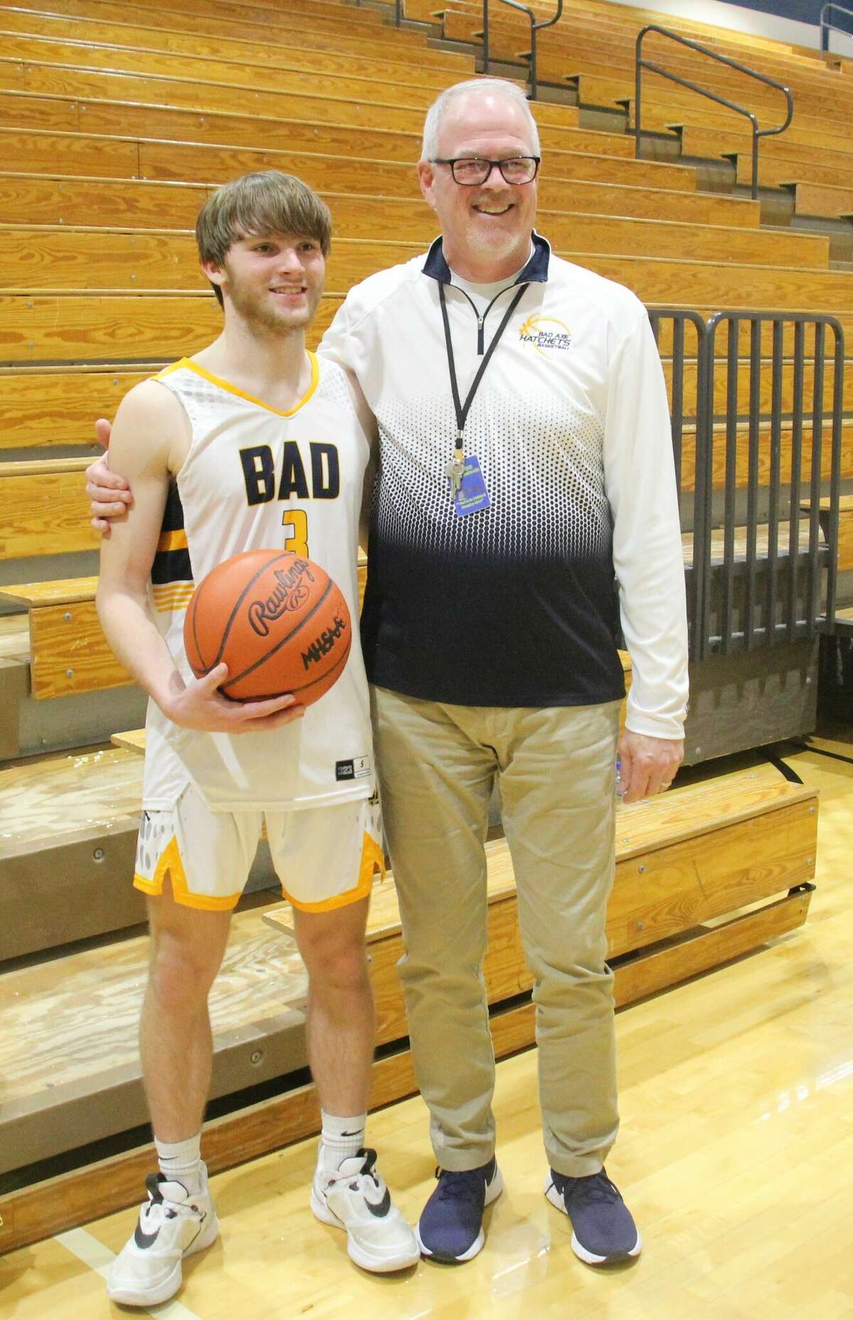 Sowles celebrates his 1,000th point with coach Mark Krug.