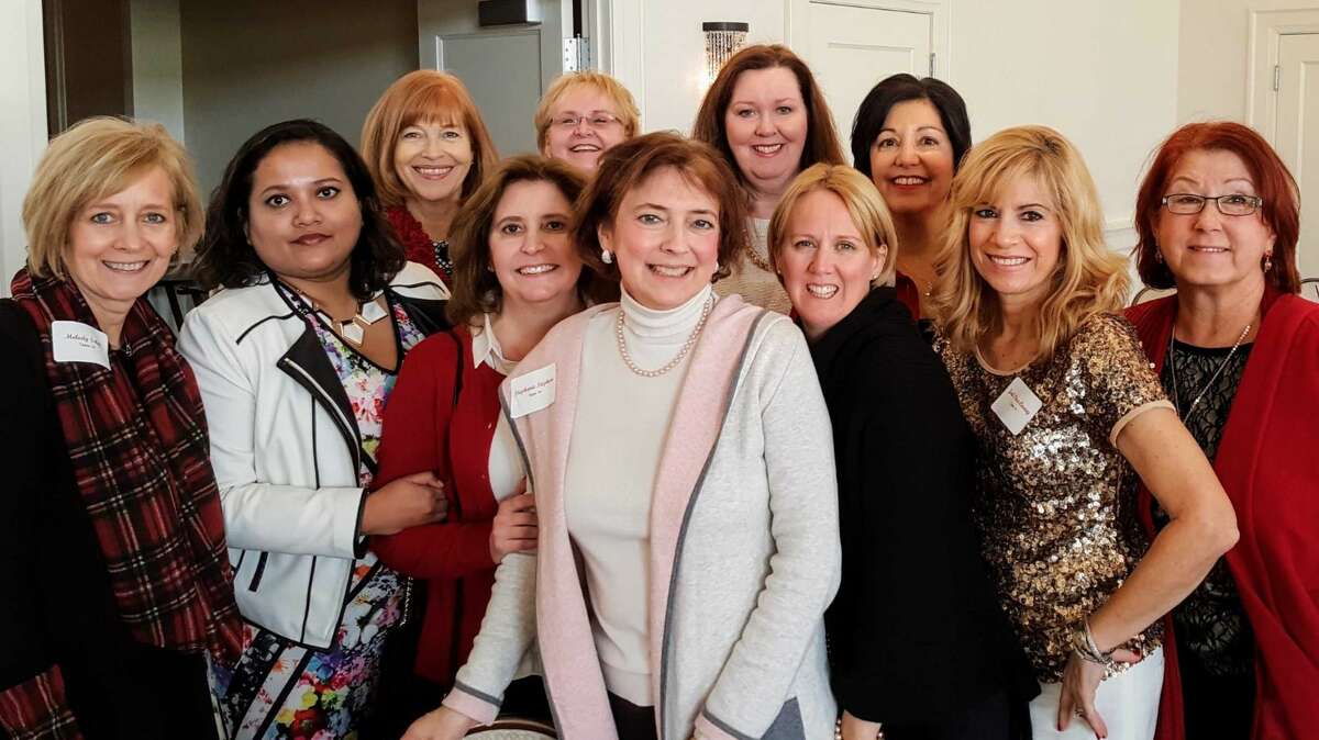 Stephanie Stephan (center) enjoys a past Cancer Services fundraising event, the Holiday Luncheon and Style Show.
