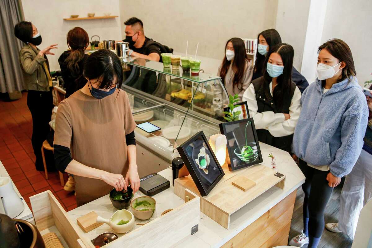 During a Three Tea Bowls pop-up, Eunice Lam mixes a matcha latte while customers watch.