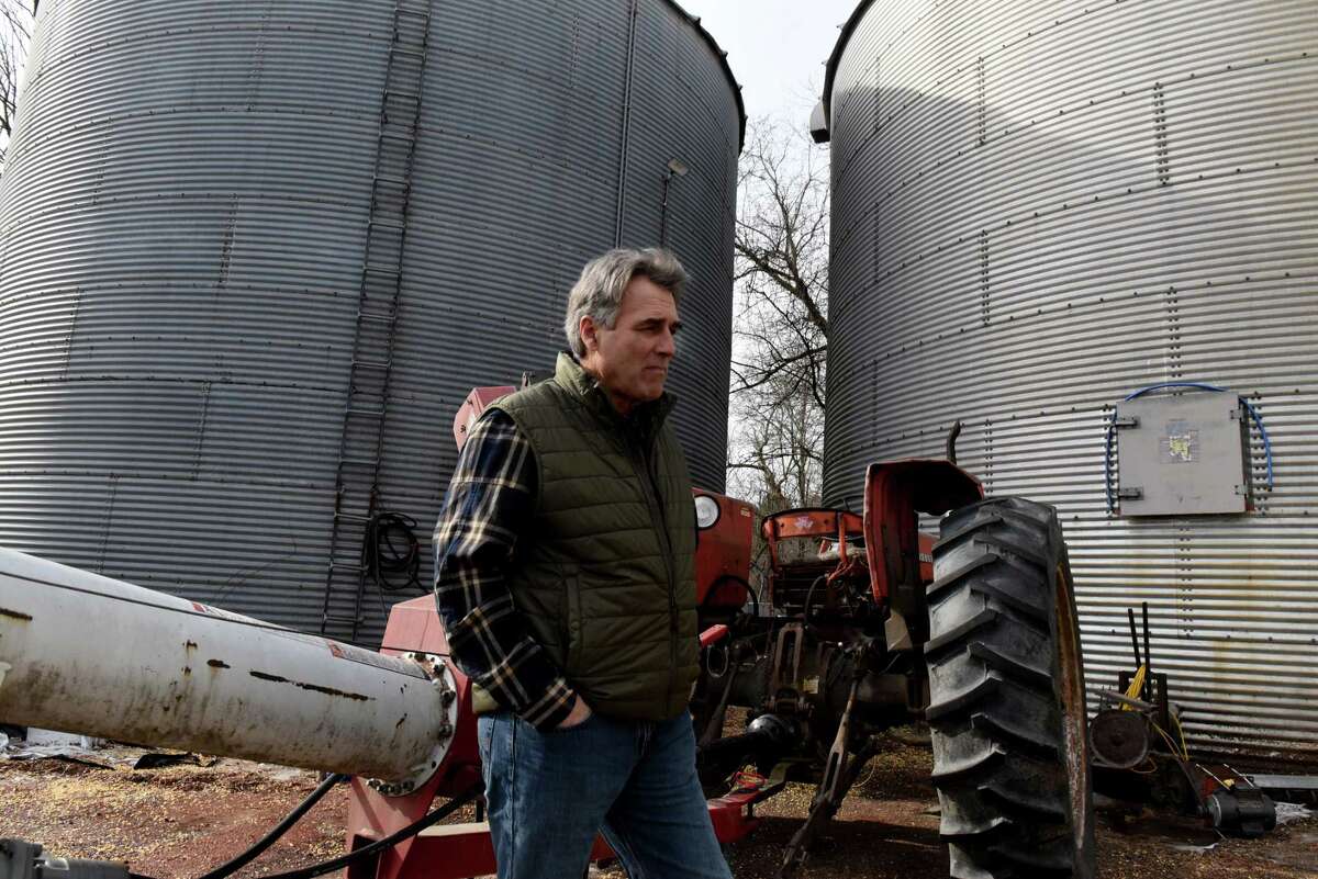 Tim Marbot, principal of Grandview Fence & Farm, stands outside his farm grain silos on Tuesday, Feb. 22, 2022, in Pittstown, N.Y. Marbot is one of many farmers struggling to navigate inflated prices for his farm supplies and tools.