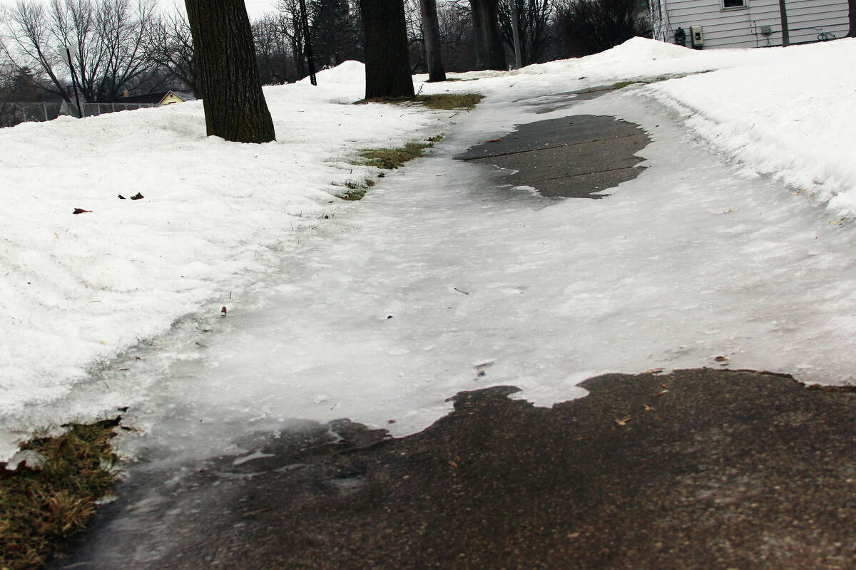 Ice lines a sidewalk in Manistee Tuesday afternoon. A winter storm watch was upgraded to an ice storm warning mid-afternoon Tuesday. 