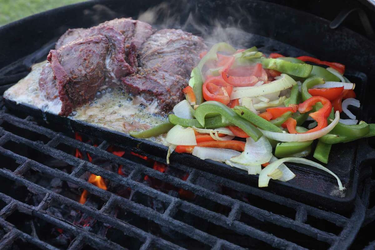 Fajitas are cooked on a cast iron griddle at Chuck’s Food Shack.