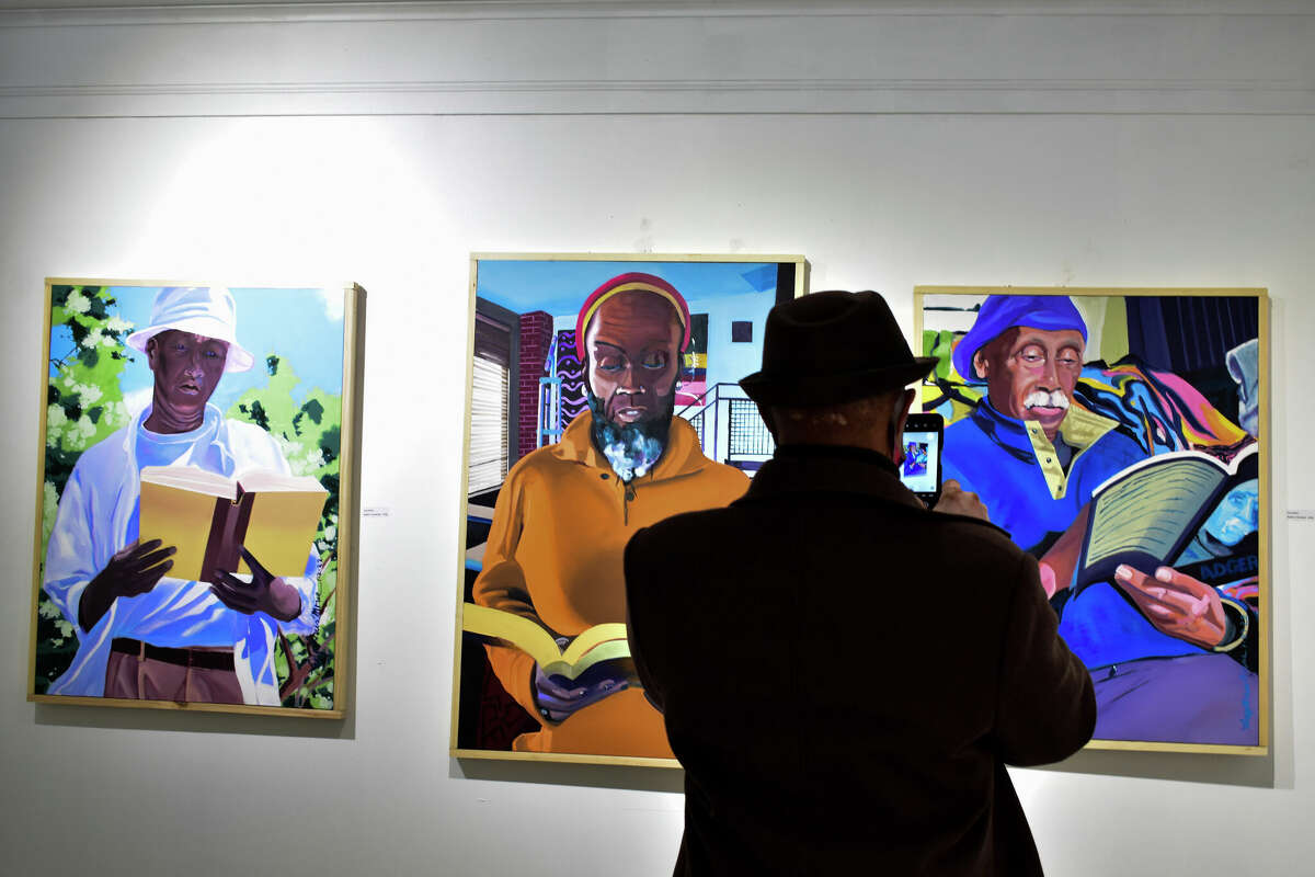 Visitors enjoy City Lights Gallery's "Absorption and Reflection" exhibit, curated by Larry Morse and showcasing the work of Iyaba Ibo Mandingo and Adger Cowans, on Feb. 20, 2022. 