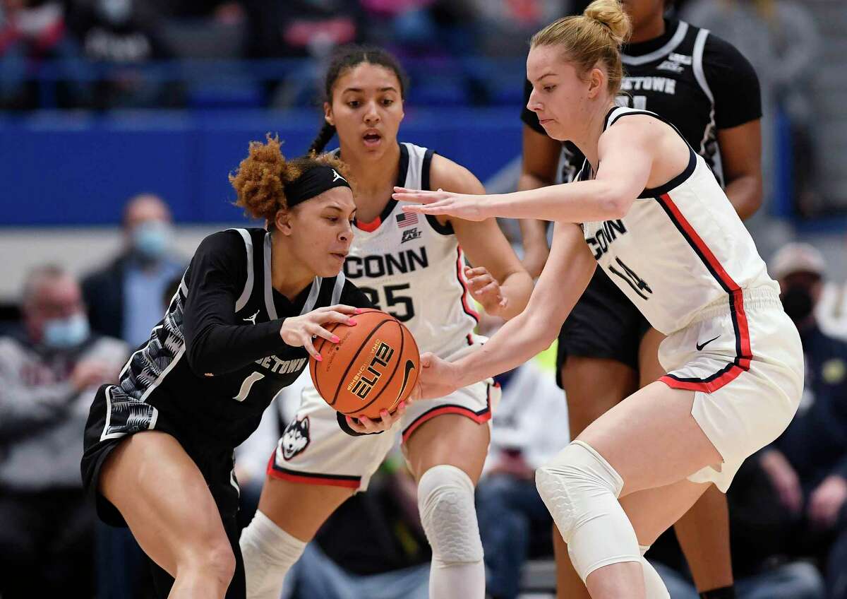 Georgetown’s Kelsey Ransom (1) is guarded by UConn’s Azzi Fudd (35) and Dorka Juhász (14) in Sunday’s game in Hartford.