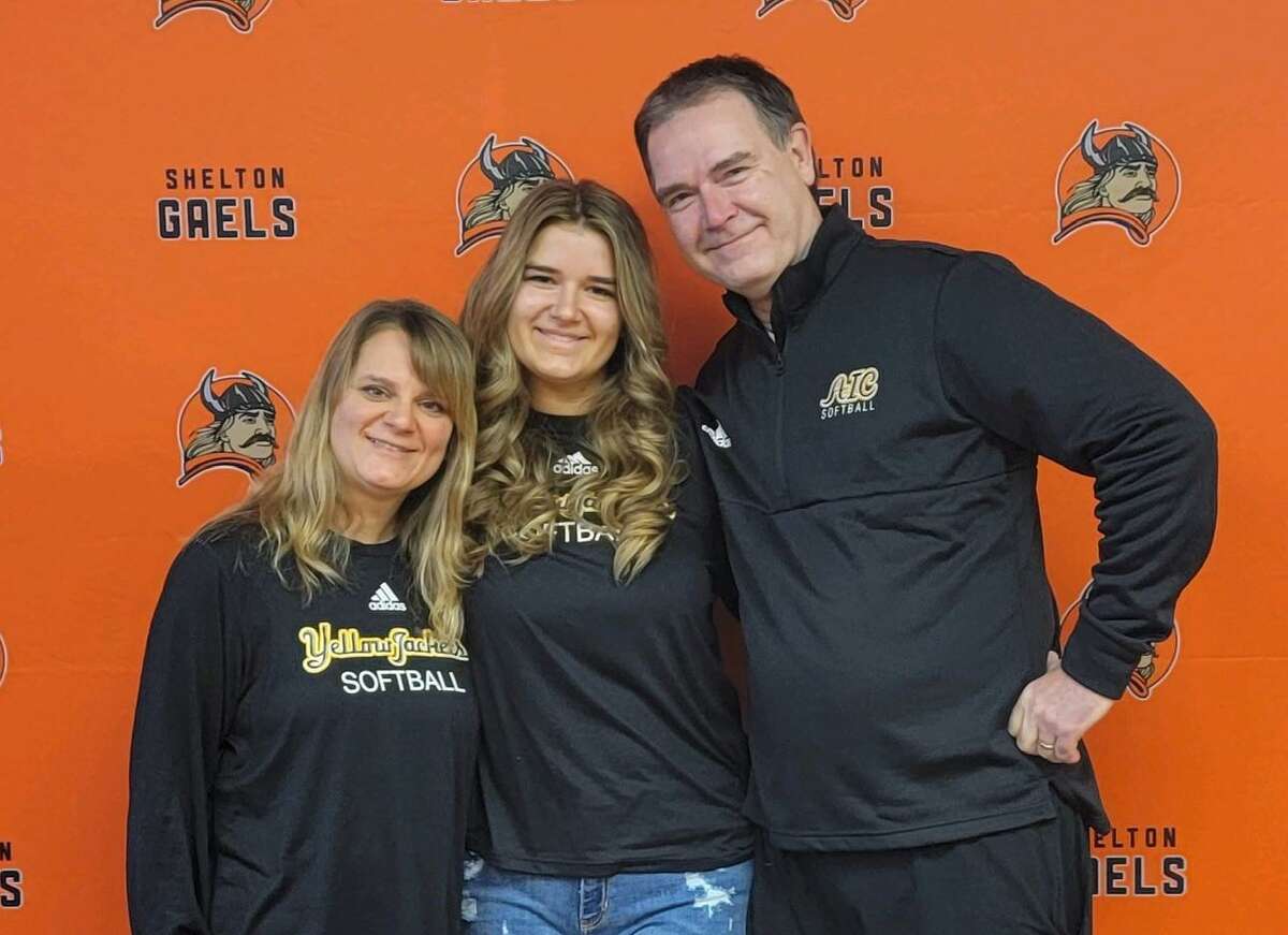 Julia Krijgsman is flanked by mom, Monika, and dad, Michael, in a signing ceremony at Shelton High.